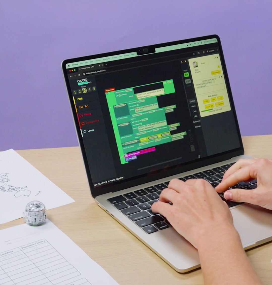 Person coding on a laptop using Ozobot Evo