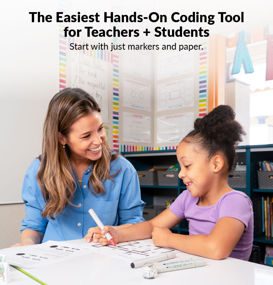 Teacher helping a student code an Ozobot Evo robot, a whole-class STEM coding tool for elementary schools